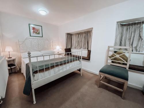 a bedroom with two bunk beds and a chair at The Blenheim Buttery in Woodstock