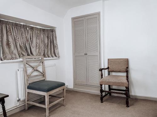 a room with two chairs and a window at The Blenheim Buttery in Woodstock