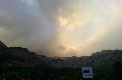 a sunset over a mountain range with a sign in the foreground at Twin Peaks Lodge & Hot Springs in Ouray