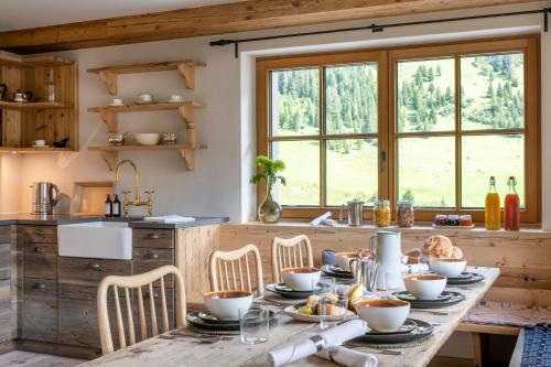 a kitchen with a wooden table with food on it at Brunnenhof Luxury Apartments in Lech am Arlberg