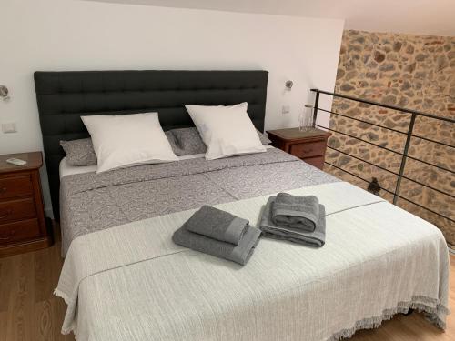 - une chambre avec un grand lit et des serviettes dans l'établissement La Grange at Laroque, à Laroque-des-Albères