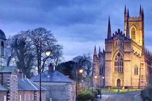 an old church with a tower and a street at Rock Quay in Killyleagh