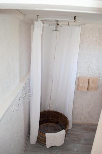 a bathroom with a tub with a shower curtain at Brakvlei in Albertinia