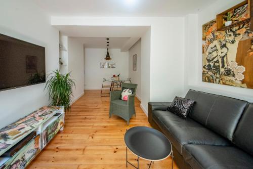 a living room with a couch and a table at Chiado Oasis with Private Garden by NestAtLisbon in Lisbon