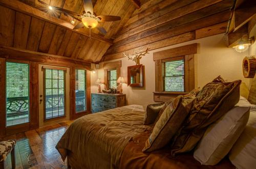 a bedroom with a bed in a room with wooden ceilings at Winding Log Ridge in Blue Ridge