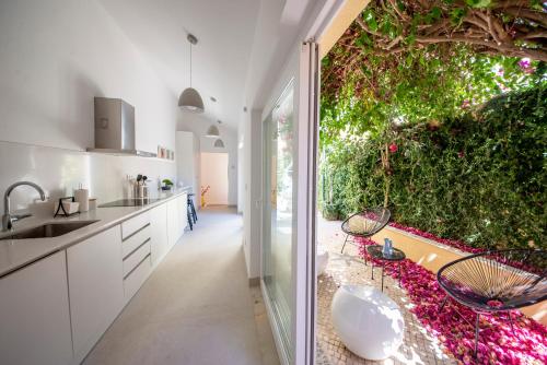 a kitchen with a large window and a garden at Chiado Oasis with Private Garden by NestAtLisbon in Lisbon