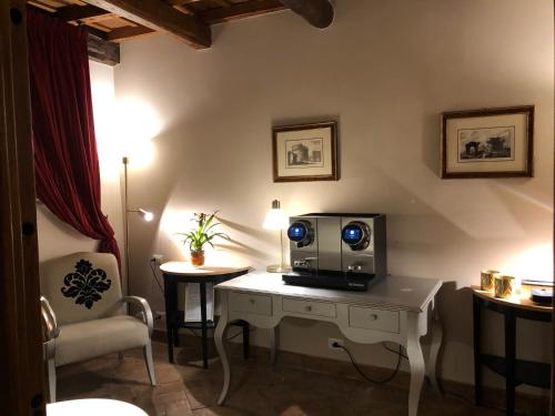 a room with a desk with a tv on it at Castle of Glamour XVI century Luxury Apartments in Rome