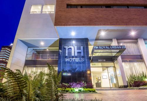a hotel with a sign on the front of a building at NH Bogota Urban 26 Royal in Bogotá