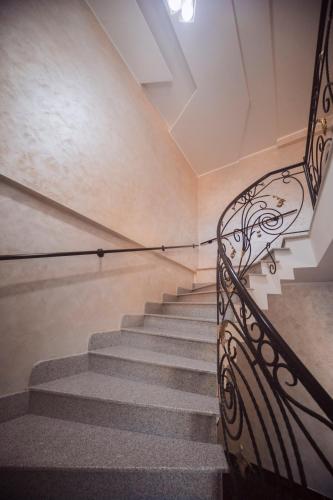 a staircase with a metal railing in a building at Makos Guest House in Kutaisi