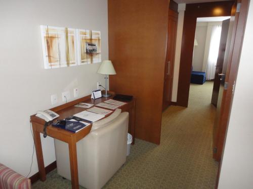 a hotel room with a toilet and a desk at Flat em Gramado in Gramado
