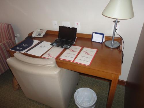 a desk with a laptop computer on top of a couch at Flat em Gramado in Gramado