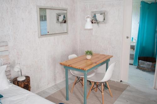 a dining room with a table and two chairs at Brakvlei 2 in Albertinia