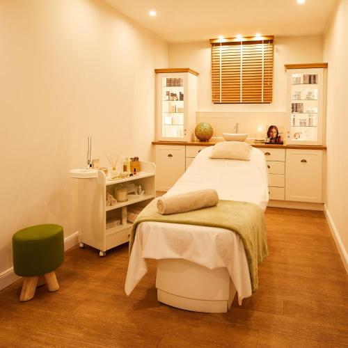 a hospital room with a bed and a sink at Fuchsbau Romantik Hotel & SPA Restaurant & FOX Bar in Timmendorfer Strand