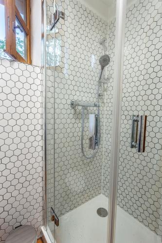 a shower with a glass door in a bathroom at Apartments No 126 Loket in Loket