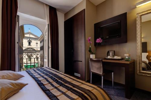 Säng eller sängar i ett rum på Hotel Rinascimento - Gruppo Trevi Hotels