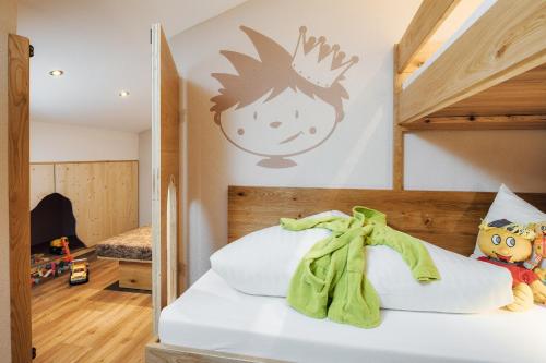 a bedroom with a bunk bed with a childs face on the wall at Kinderhotel Laderhof in Ladis