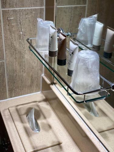 a bathroom with a sink and a shelf with toiletries at The Liner at Liverpool in Liverpool