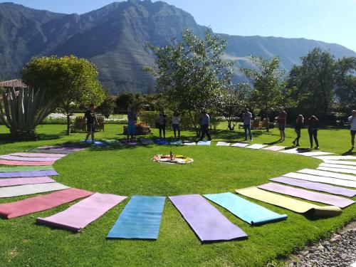 a group of people standing around a circle of yoga mats at Hotel La Casona De Yucay Valle Sagrado in Urubamba