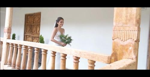 a woman is standing on a staircase holding a bouquet at Hotel La Casona De Yucay Valle Sagrado in Urubamba