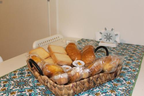 a basket of bread sitting on a table at Casa Turà in Isola delle Femmine