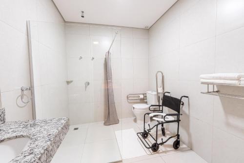 a bathroom with a shower, sink, and toilet at Prime Hotel Ponta Porã in Ponta Porã
