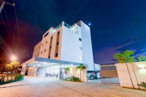 a large white building with a parking lot at night at Prime Hotel Ponta Porã in Ponta Porã