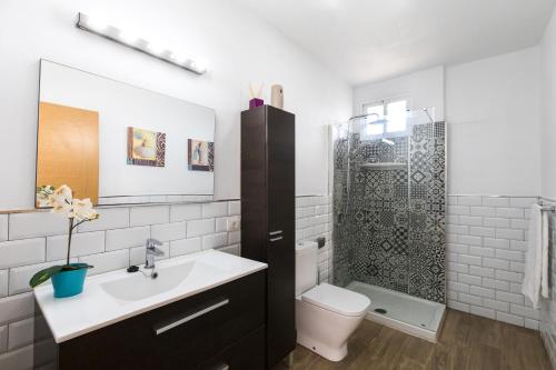 a bathroom with a sink and a toilet and a shower at JVG VILLAS - Villa Joval in Güimar