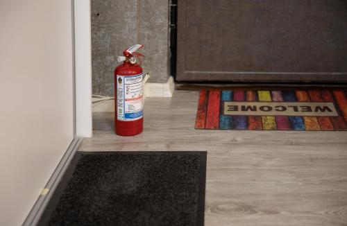 a fire extinguisher sitting on the floor next to a door at Aquarium Apartment Grivita in Bucharest