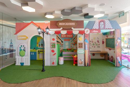 a play room with a doll house in a store at Novotel Itu Terras de São José Golf & Resort in Itu