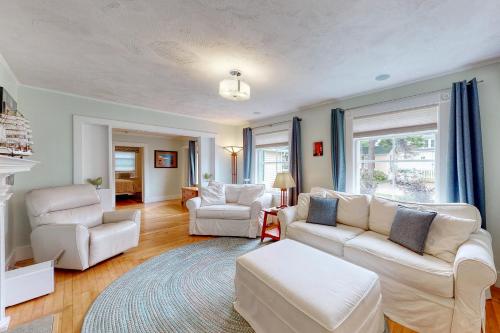 a living room with two white couches and chairs at Acadia Cottage in Bar Harbor