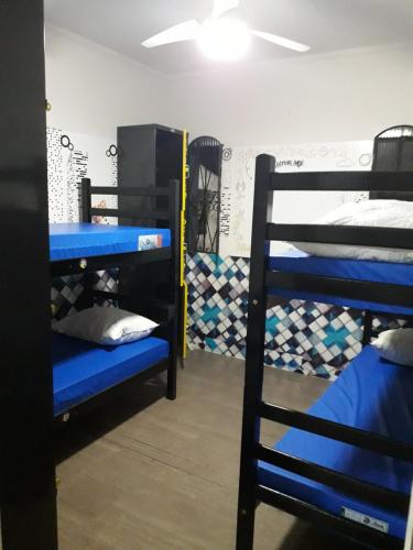 a room with blue bunk beds in a dorm at O HOSTEL GRU SP - Airport - Centro - Hospedagem, Traslado, Alimentação e Conveniências in Guarulhos