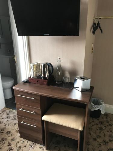 a desk in a room with a television on top at Braehead Guest House in Inverness