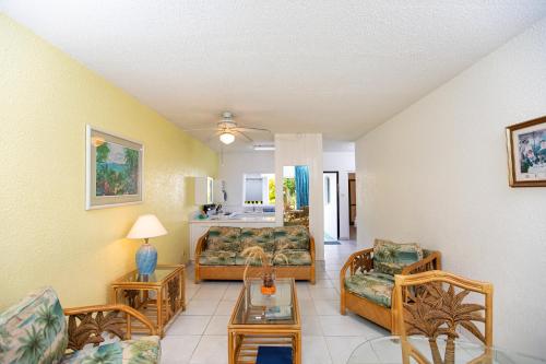 a living room with a couch and a table at Plum Tree Club in Bridgetown