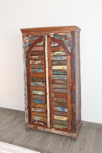 an old wooden cabinet with a bunch of doors at CA' DA TOLLO in Cogorno