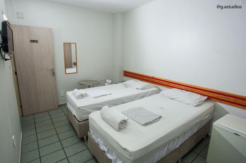 Säng eller sängar i ett rum på HOTEL ZURIQUE