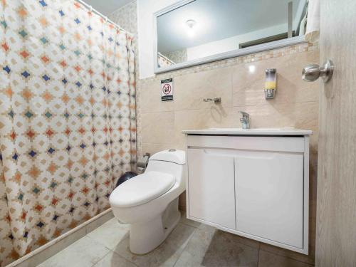 a bathroom with a toilet and a sink and a shower at Casa Borbon in Salento