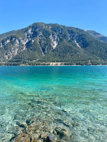a large body of water with a mountain in the background at Haus Huberta in Achenkirch