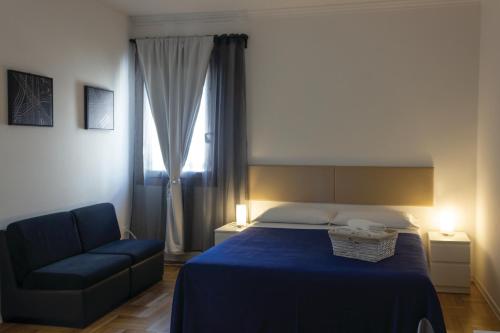 a bedroom with a blue bed and a blue chair at Canton del Gallo in Padova