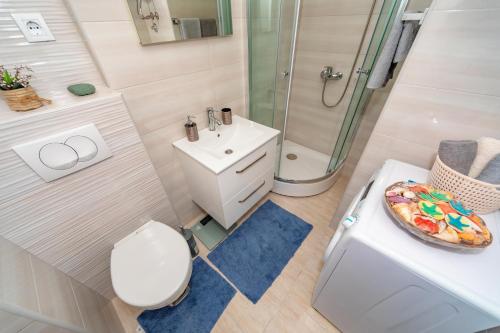 a bathroom with a toilet sink and a shower at Sea&Center Lux in Bar