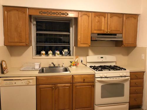 a kitchen with a sink and a stove top oven at Beautiful Quiet Neighborhood in Miami