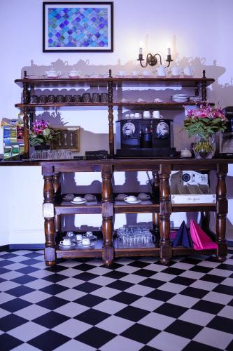 an antique table in a room with a checkered floor at SmartHotel Mystique Self check-in in Bad Homburg vor der Höhe