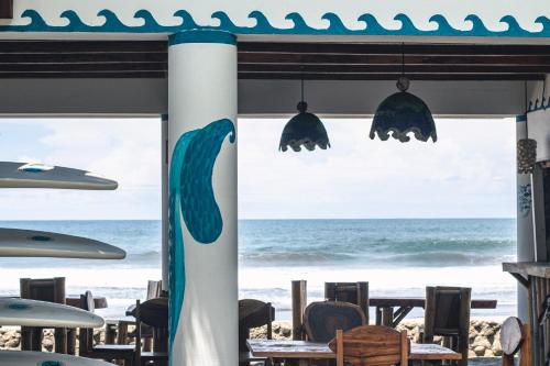a view of the ocean from a beach restaurant at Olas Permanentes El Zonte in El Zonte