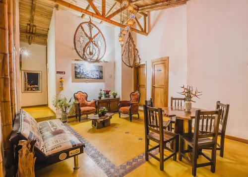 a living room with a table and chairs at Ecohotel Piedemonte in Salento