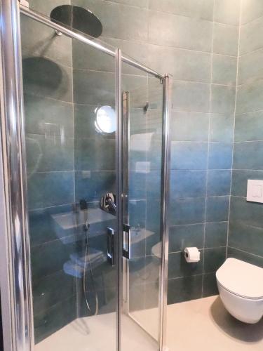 a bathroom with a shower with a toilet at Relais Villa Montedonzelli in Naples