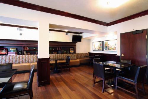 a restaurant with tables and chairs and a bar at Oxford Suites Spokane Valley in Spokane Valley