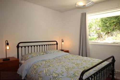 a bedroom with a bed and a window at Carawatha in Blackheath