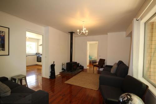 a living room with a couch and a fireplace at Carawatha in Blackheath