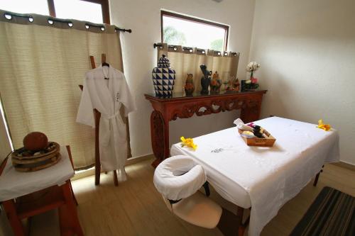 a room with a white table and a chair and a table and a room with at Hotel Concierge Flor y Canto in Tepoztlán