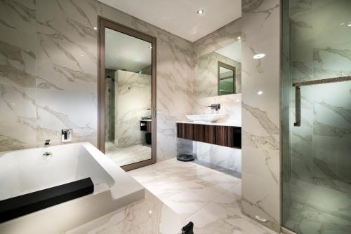 a bathroom with two sinks and a mirror at Swan River Hotel in Perth