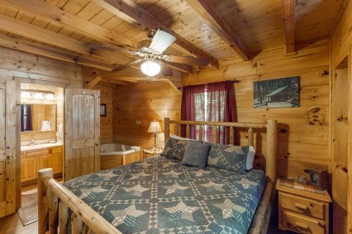 um quarto com uma cama num chalé de madeira em A Bearz Haven em Sevierville